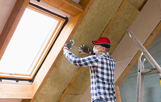 Man installing thermal roof insulation.