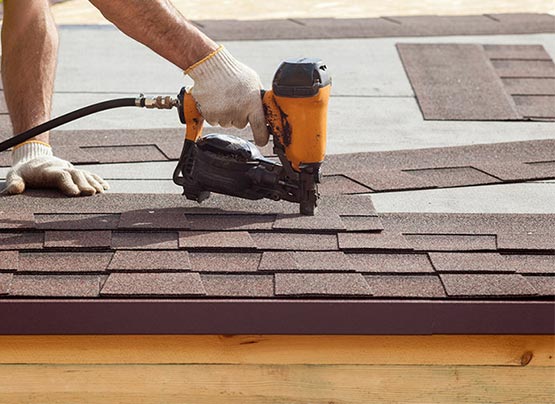 Professional worker installing roof