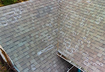 Roof showing hail damage and markings, indicating the need for repair.