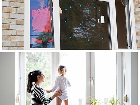 Professional worker installing window, Mom and her kid looking outside through window